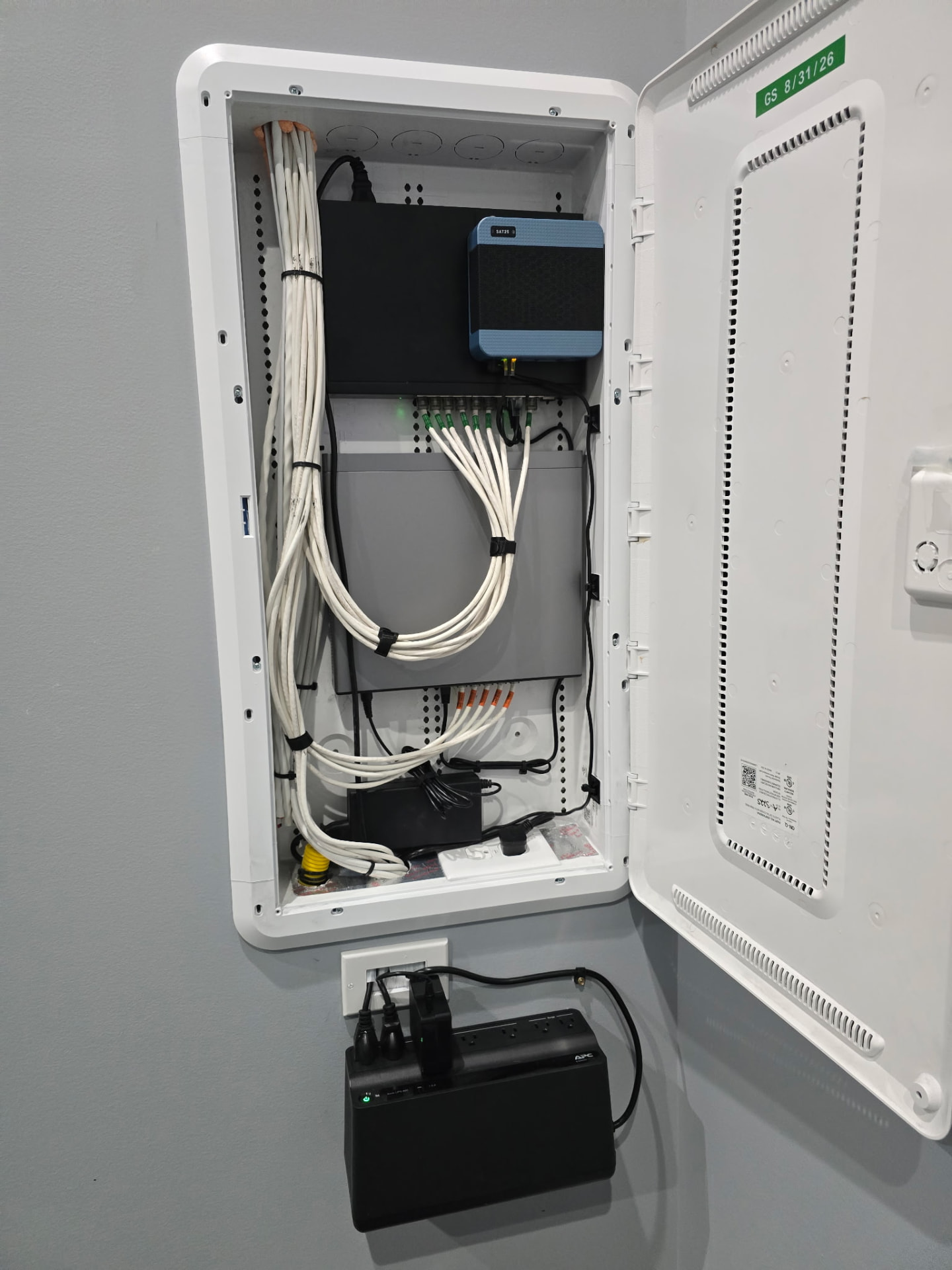 Wall-mounted structured media enclosure with network switch, Ethernet cabling and backup power